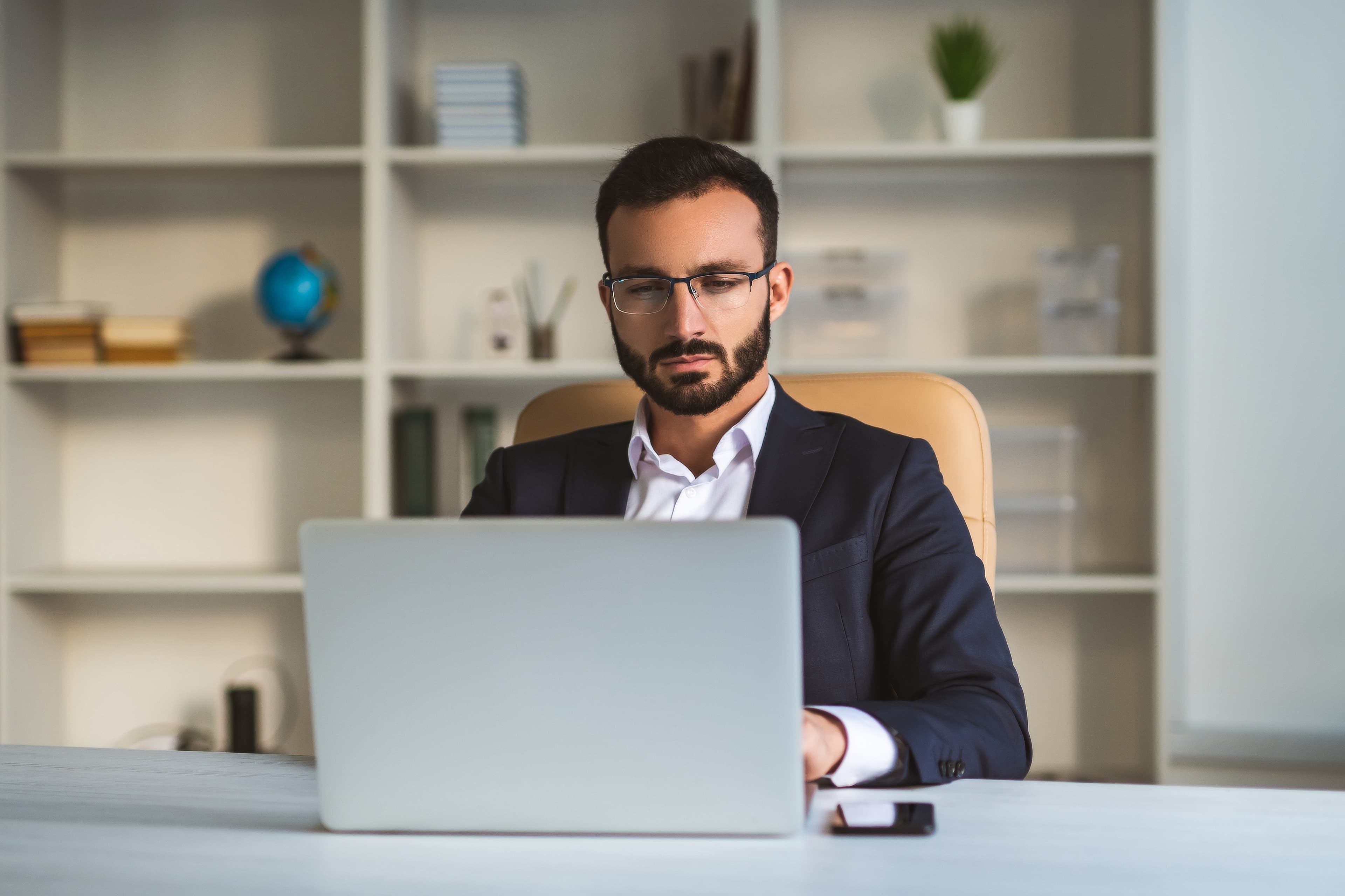 cyber security professional wokring on a laptop