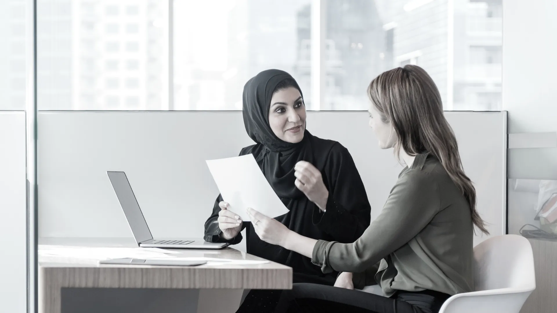 Two UAE compliance professionals discussing a GRC strategy